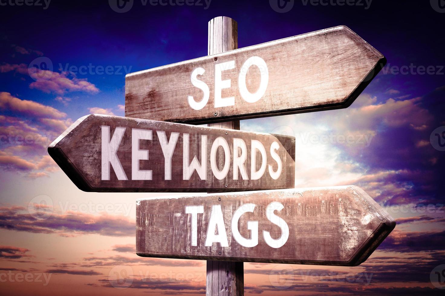 SEO, Keywords, Tags - Wooden Signpost with Three Arrows, Sunset Sky in Background photo