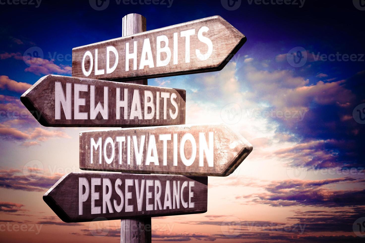 Old Habits, New Habits, Motivation, Perseverance - Wooden Signpost with Four Arrows, Sunset Sky in Background photo