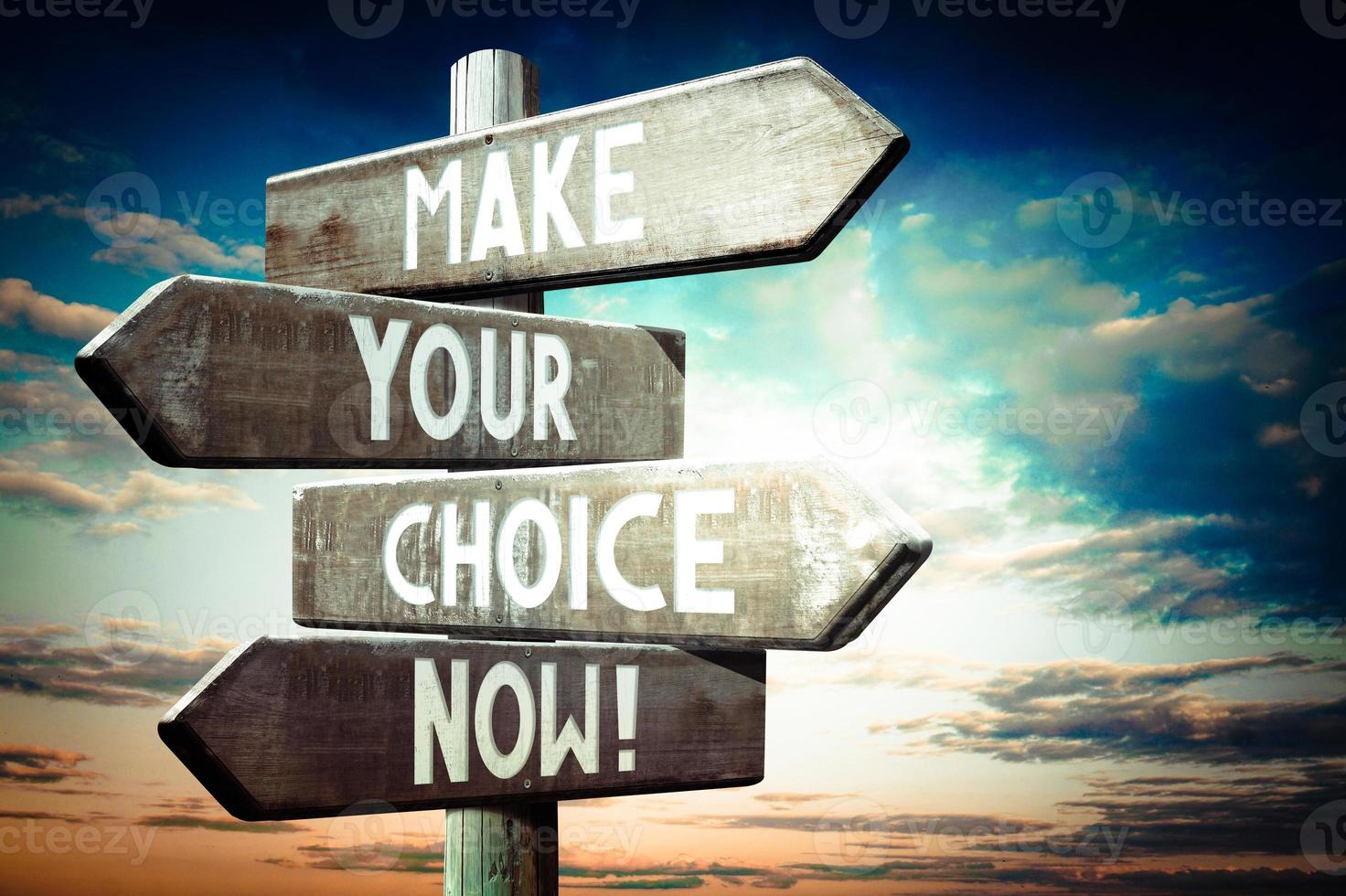 Make Your Choice Now - Wooden Signpost with Four Arrows, Sunset Sky in Background photo