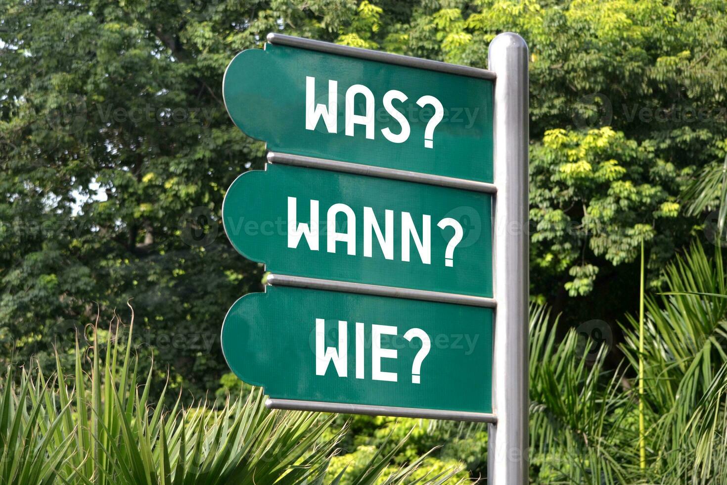 What, When, How Questions in German - Green Metal Signpost photo