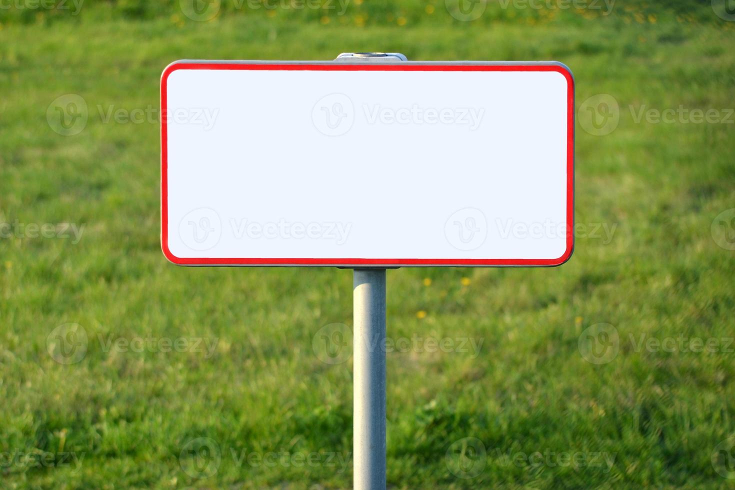 Clear White Metal Sign Standing on a Grass photo