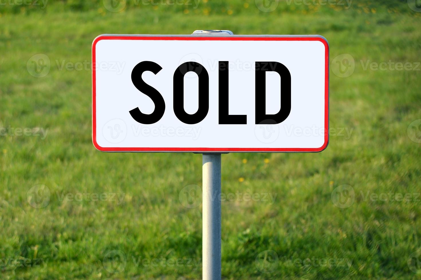 Sold - White Sign on a Grass photo