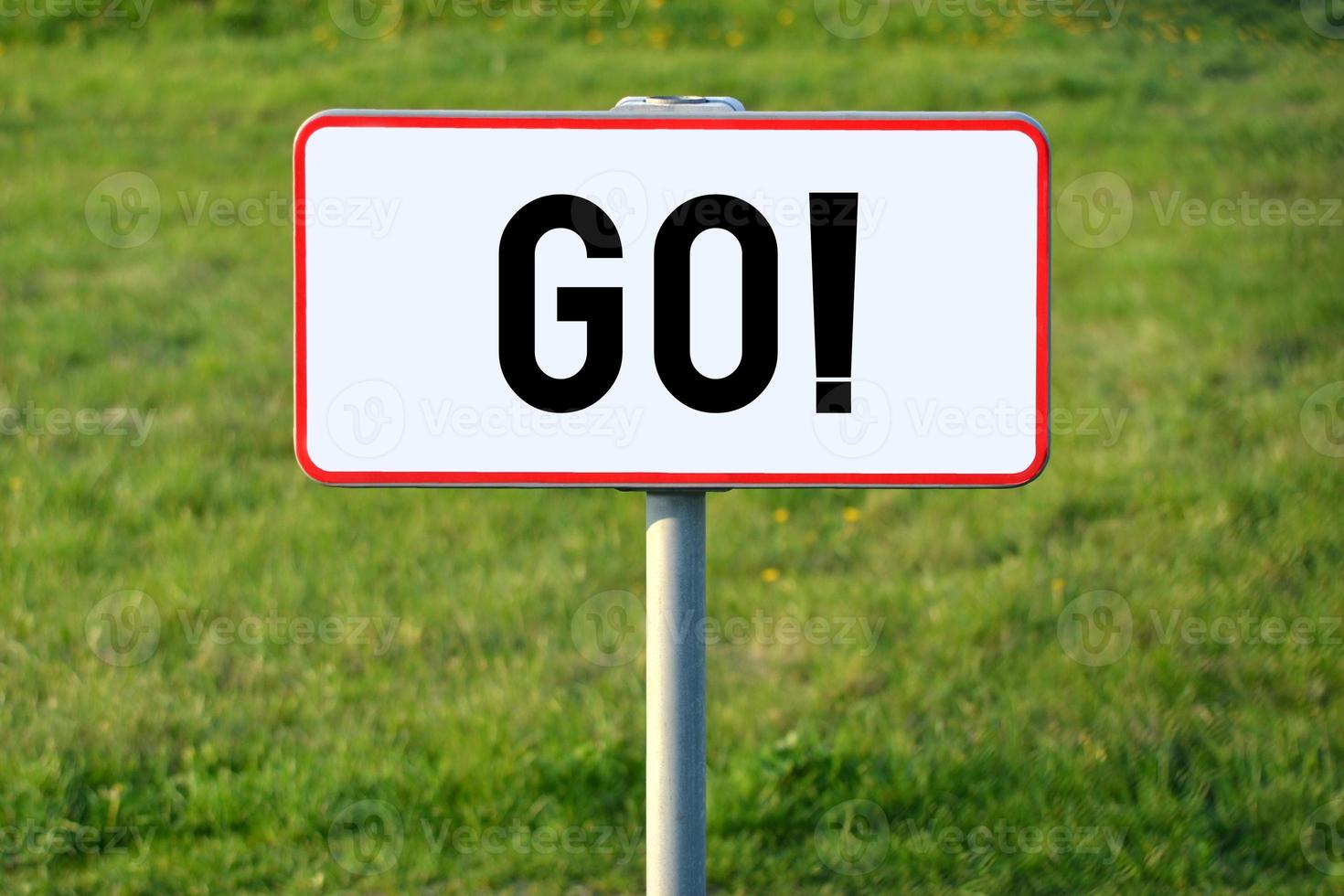 Go - White Sign on a Grass photo