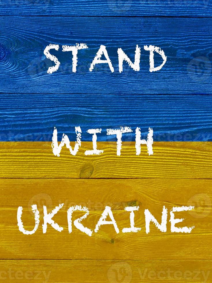 slogan Stand with Ukraine on painted Ukrainian flag photo