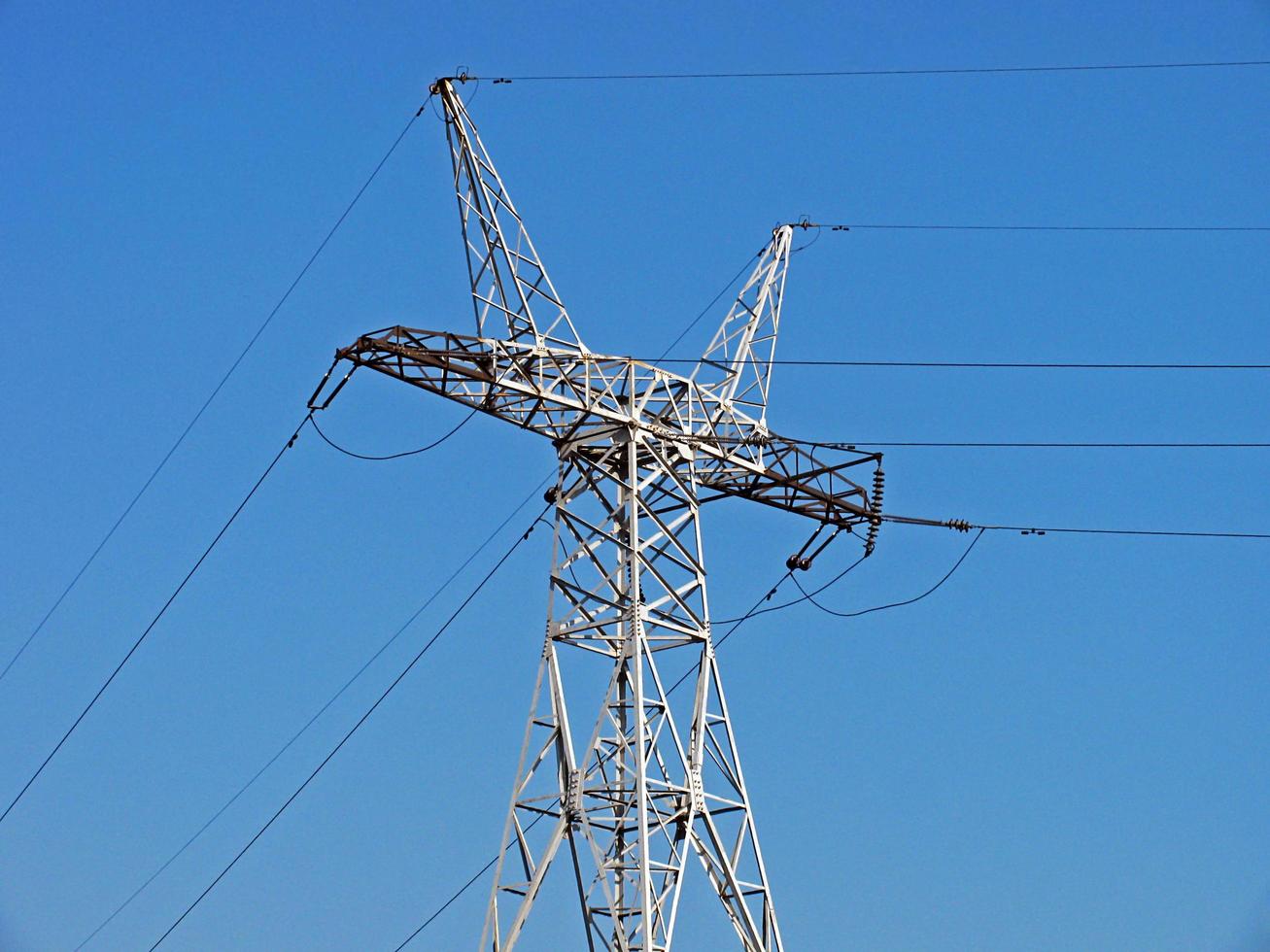 electricity pylon against blue sky photo