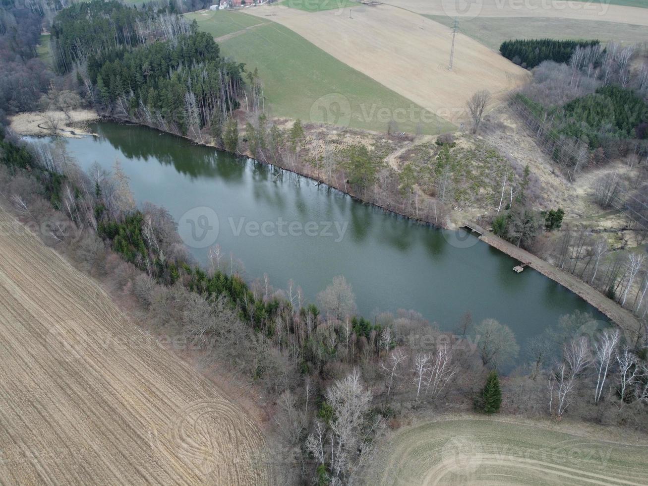Aerial view of natural pond near the town of Havlickuv Brod, Czech Republic. Forest after bark beetle calamity photo