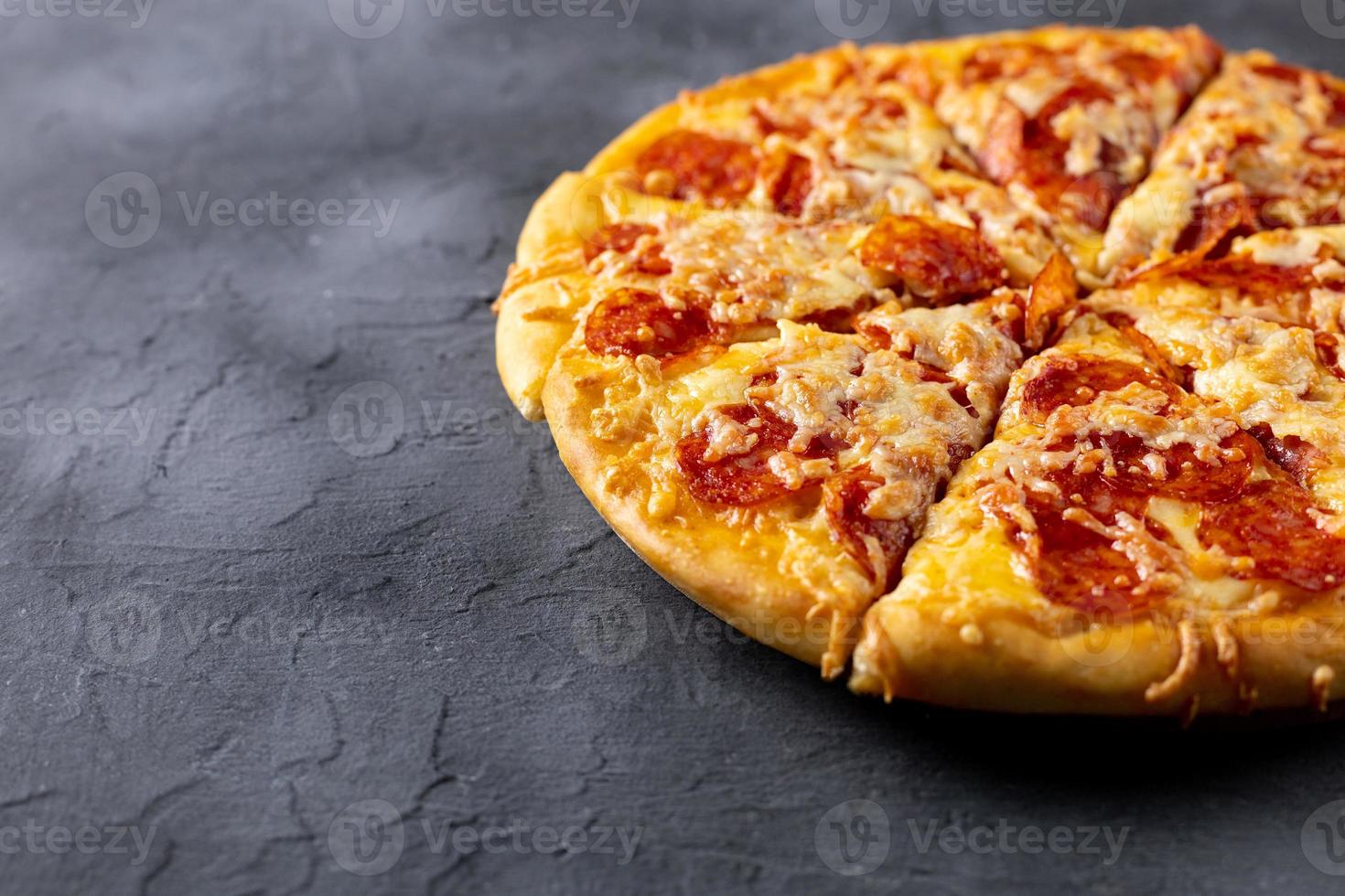 Tasty hot homemade pepperoni pizza. Traditional classic pizza with salami and cheese. With copy space for text. photo