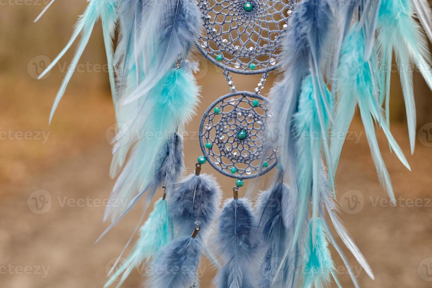 Handmade dream catcher with feathers threads and beads rope hanging photo