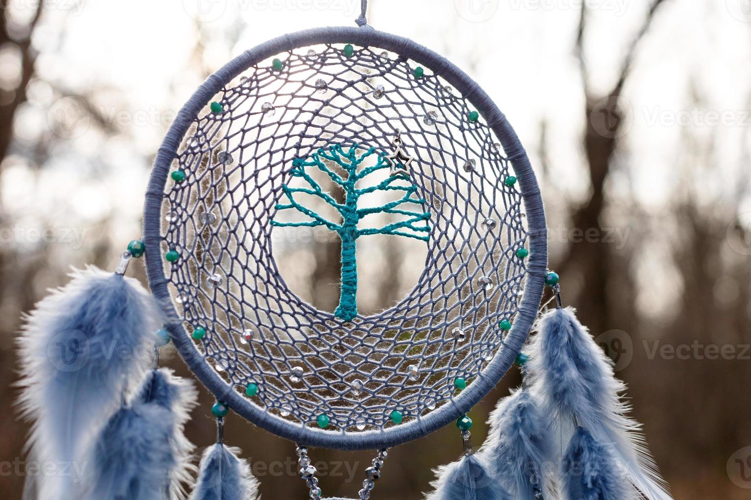 Handmade dream catcher with feathers threads and beads rope hanging photo