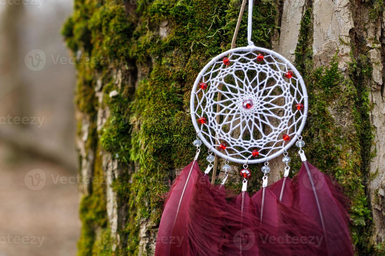 Handmade dream catcher with feathers threads and beads rope hanging photo