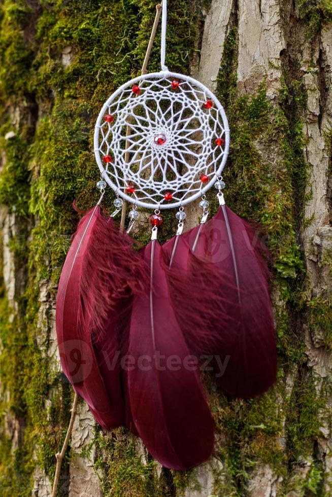 Handmade dream catcher with feathers threads and beads rope hanging photo