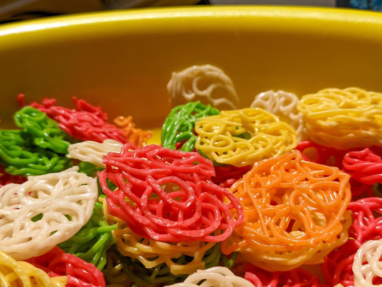 A close up of raw buckwheat crackers or kerupuk mentah with various colors photo