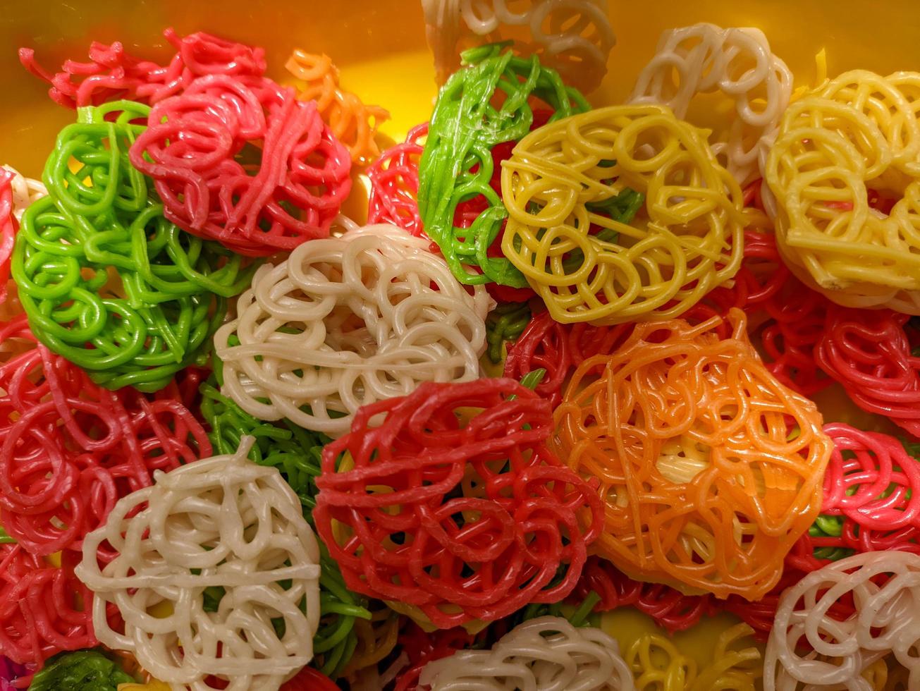 A close up of raw buckwheat crackers or kerupuk mentah with various colors photo