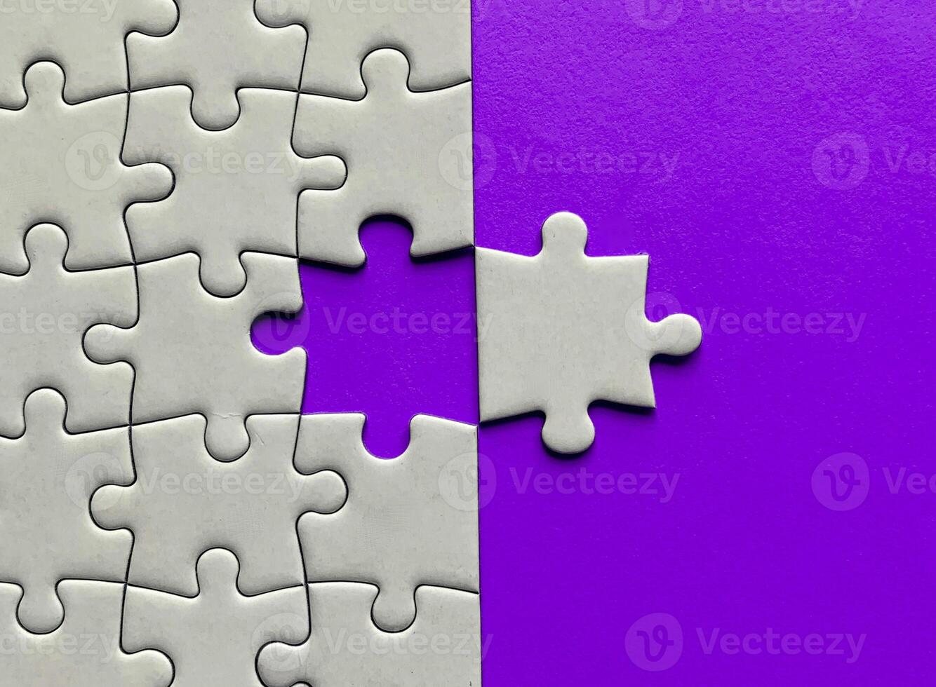 Top view of missing jigsaw puzzle with customizable space for text on maroon color background. Copy space concept. photo