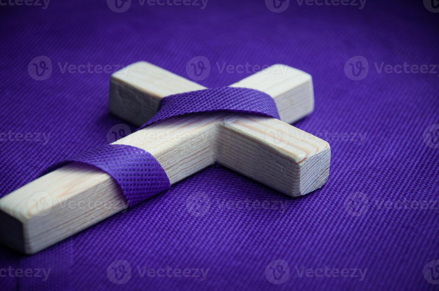 Religious cross on purple background. Good Friday concept photo