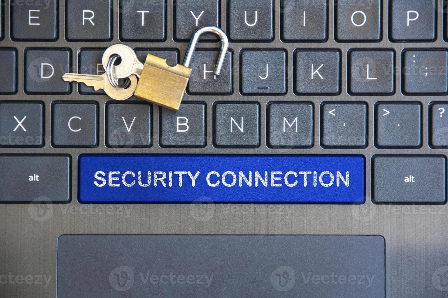 Security connection text on blue laptop space bar with locker background. photo