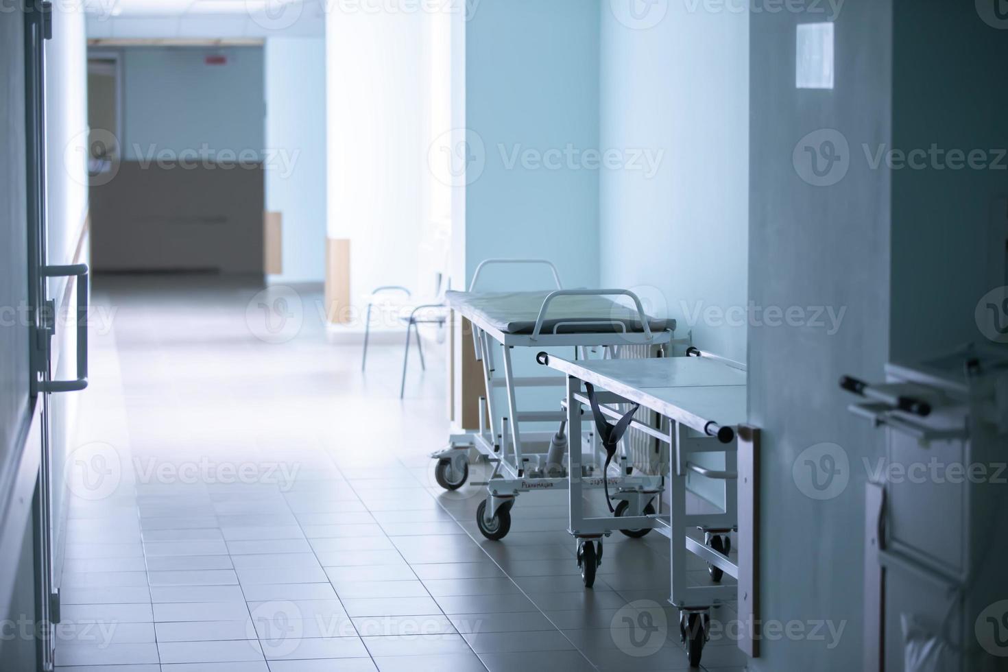 Empty hospital corridor with medical gurneys. photo