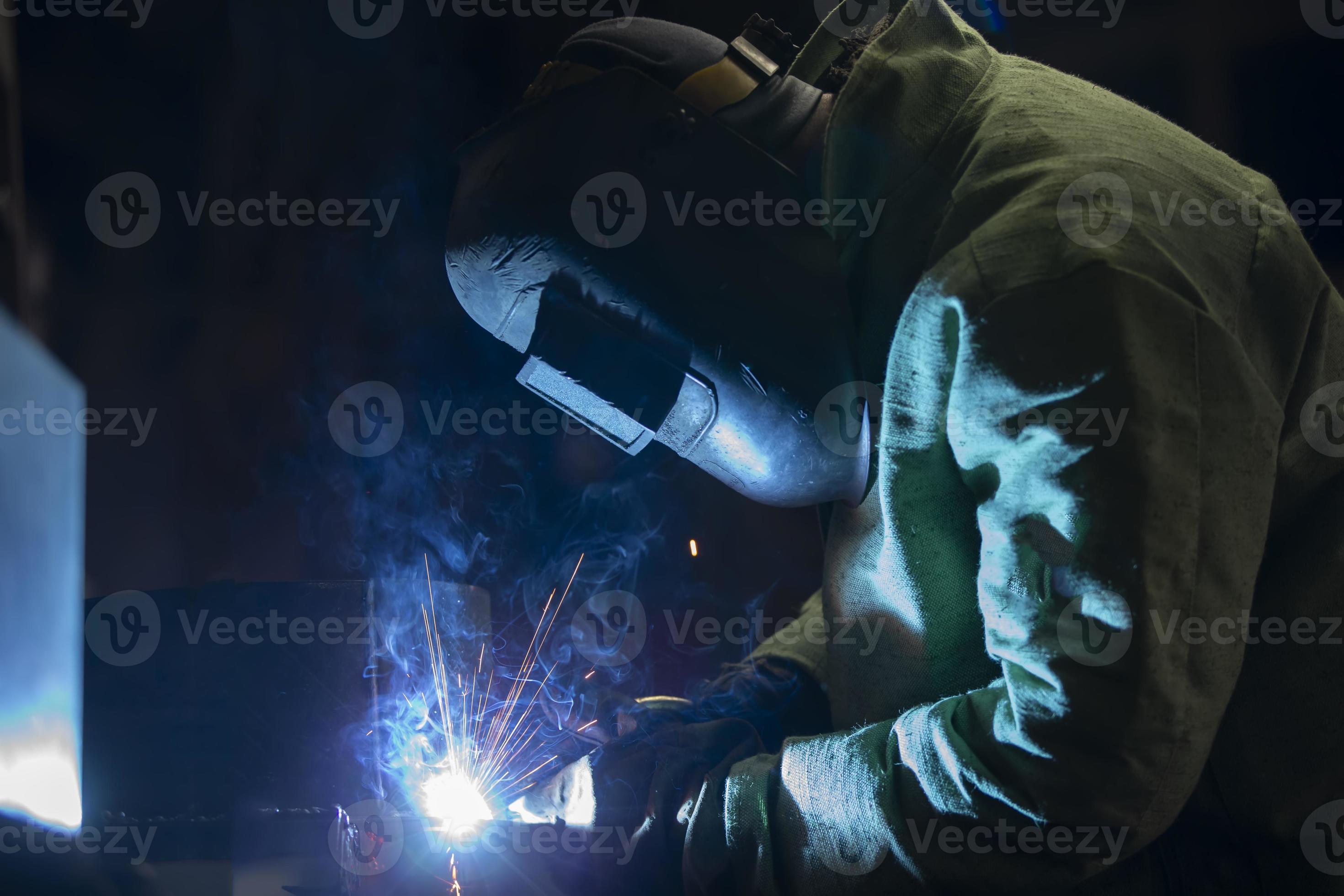 A worker in a welding suit Welding work with flying sparks. 21683332