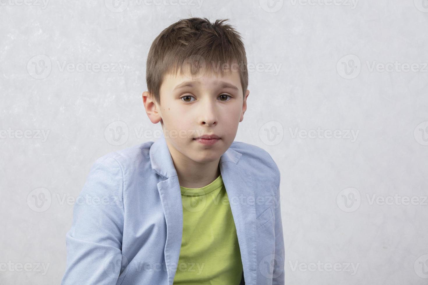 Portrait of a boy of middle school age in a jacket. The child is ten years old. photo