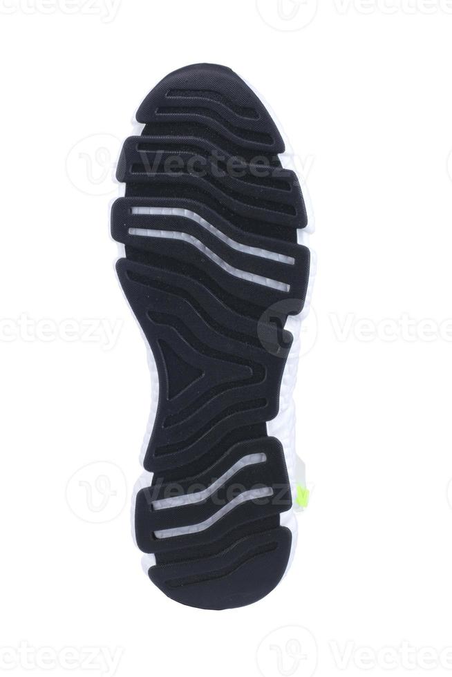 Black rubber sole of the sneaker with white inserts isolated. photo