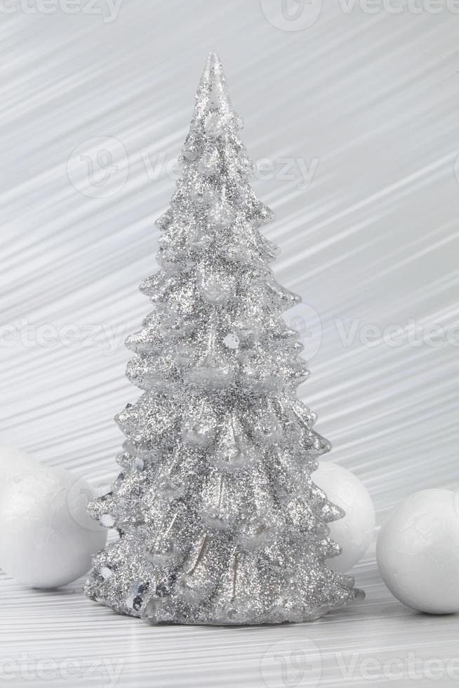 Christmas or New Year background with silver snowy tree and white transitional decoration. Bright festive background. photo