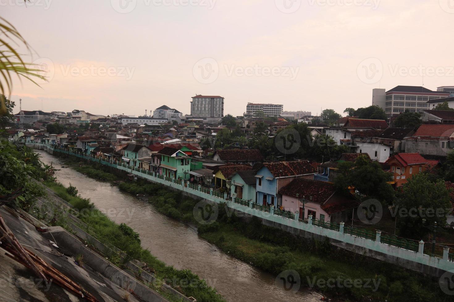 Slum housing on the outskirts of town beside the river photo