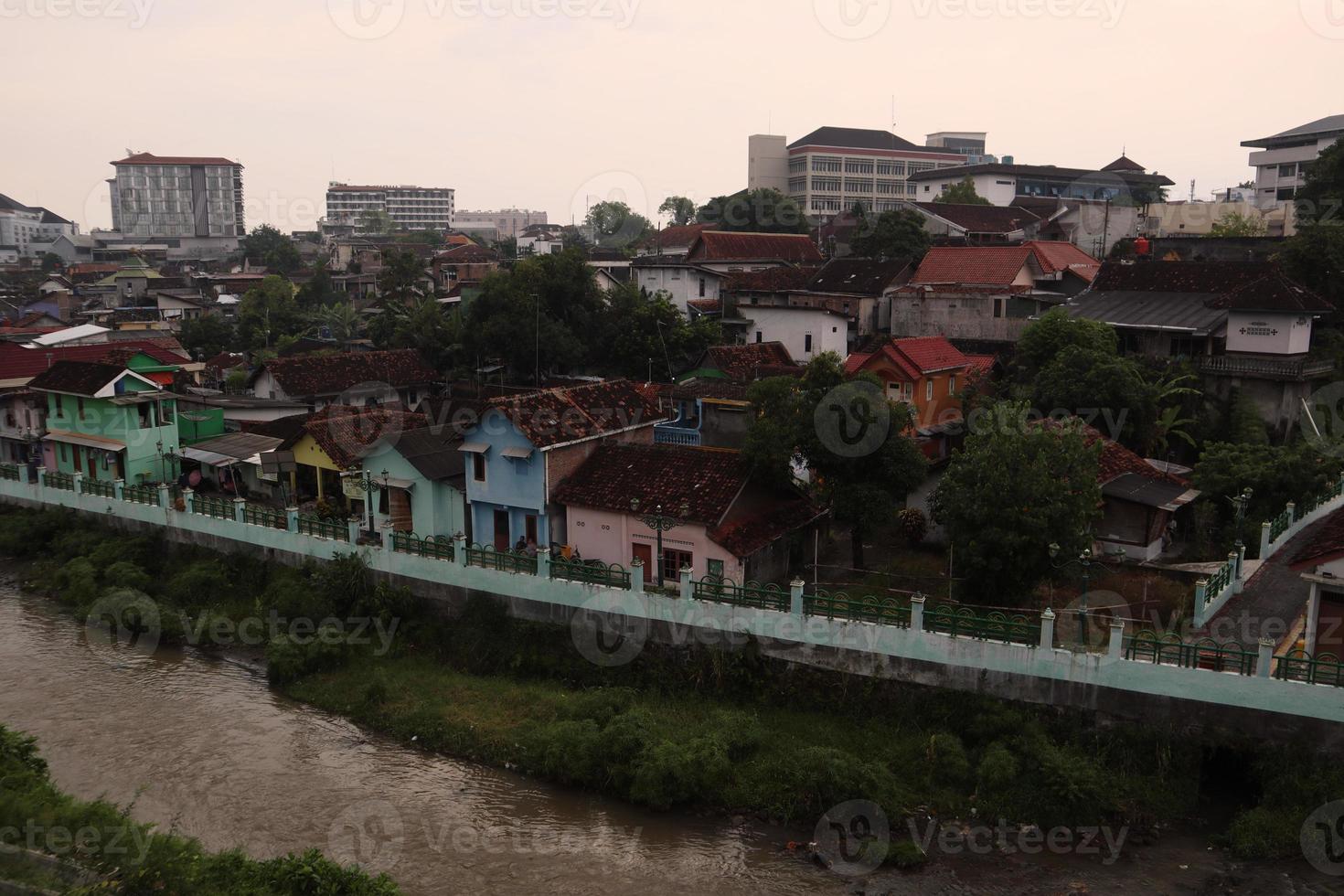 Slum housing on the outskirts of town beside the river photo