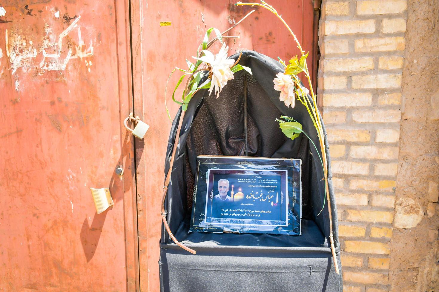 Yazd, Iran, 2022 - iranian man memorial stand with portrait photo picture man in street. Death in persian culture concept and persian culture