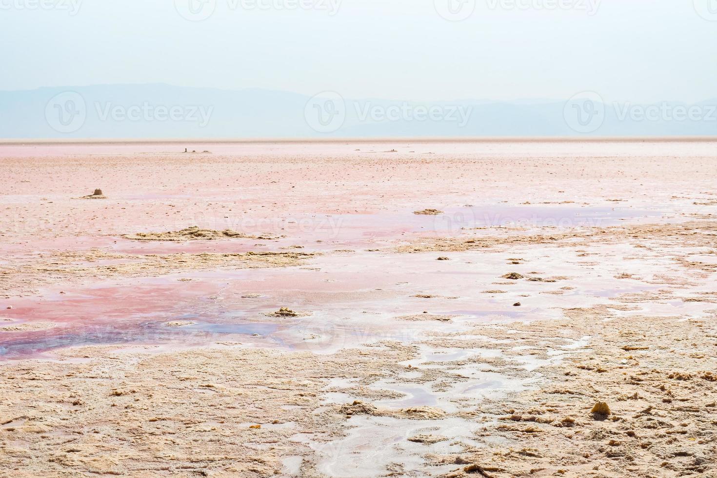 Panning view close up salt mineral particles macro on Tuz salt lake in Turkey . Tuz golu panorama with horizon in sunny summer day photo