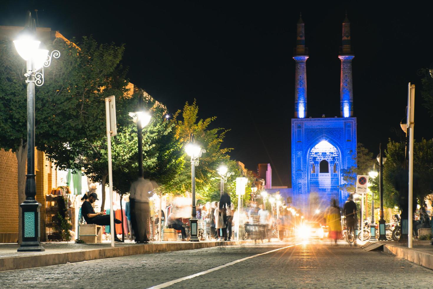 Yazd, Iran ,2022 - Blue Hazireh Mosque during night in Yazd, Iran. Blue hour street scene with pedestrians and traffic photo