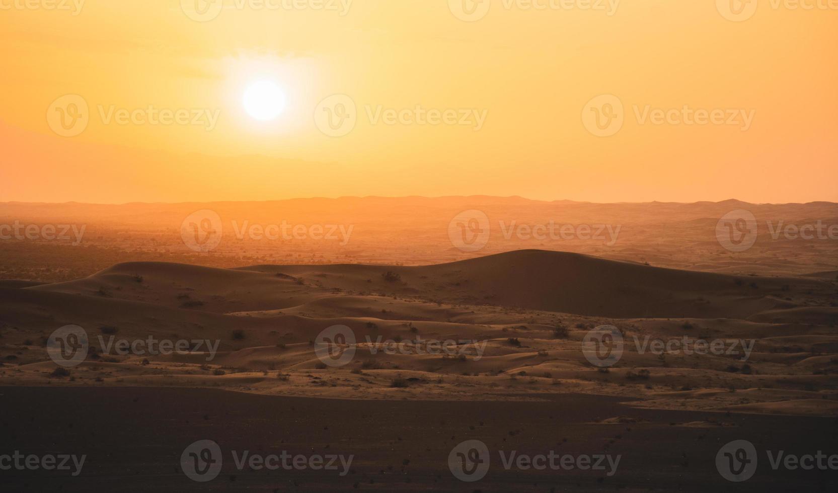 Sunset at the Edge of the Rolling Sand Dunes in the Empty Quarter Arabian Desert outside Abu Dhabi, United Arab Emirates photo