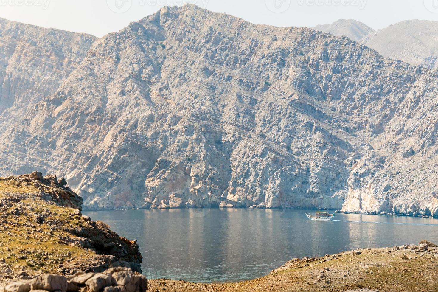 Traditional tour boat on water on cruise in persian gulf. Oman travel famous leisure activities photo
