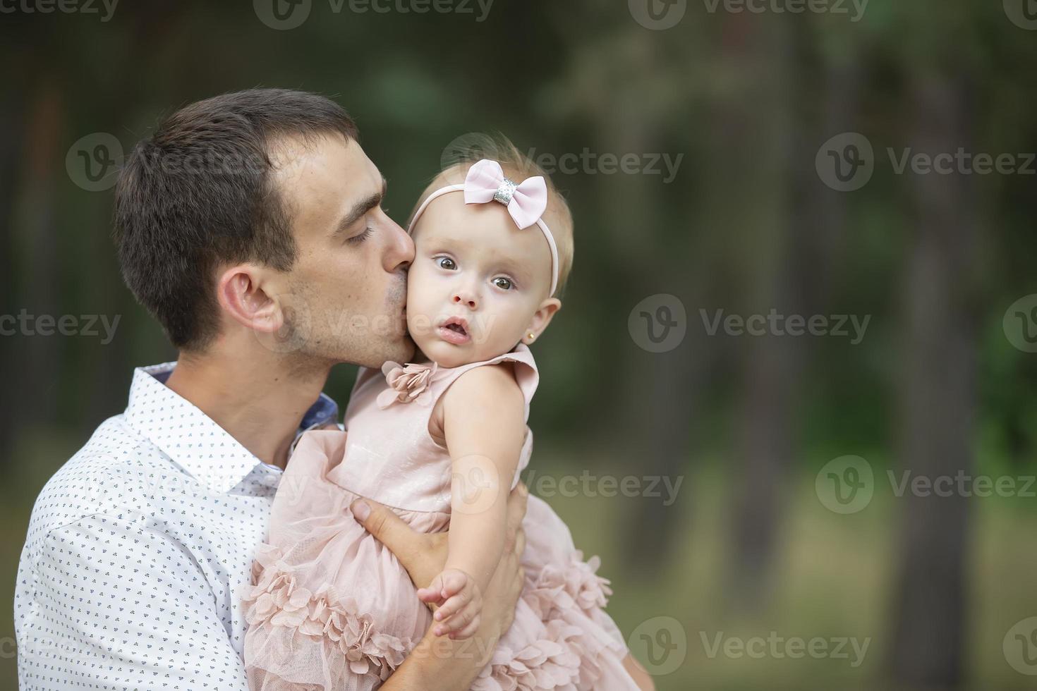 Happy dad plays with his little daughter for a walk. Paternity. photo