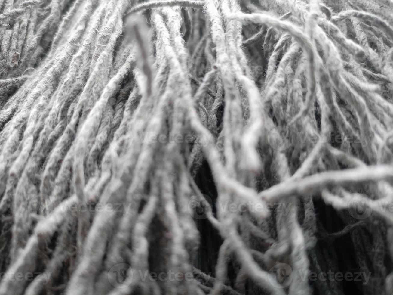 Close up of mop head, upside down and drying in the sun, cloth for mopping the floor photo
