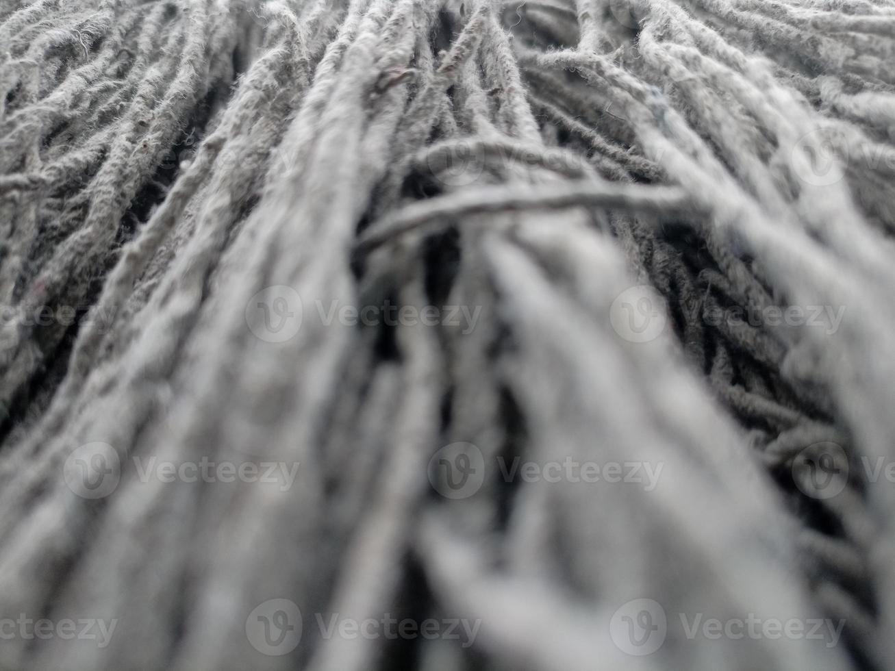 Close up of mop head, upside down and drying in the sun, cloth for mopping the floor photo