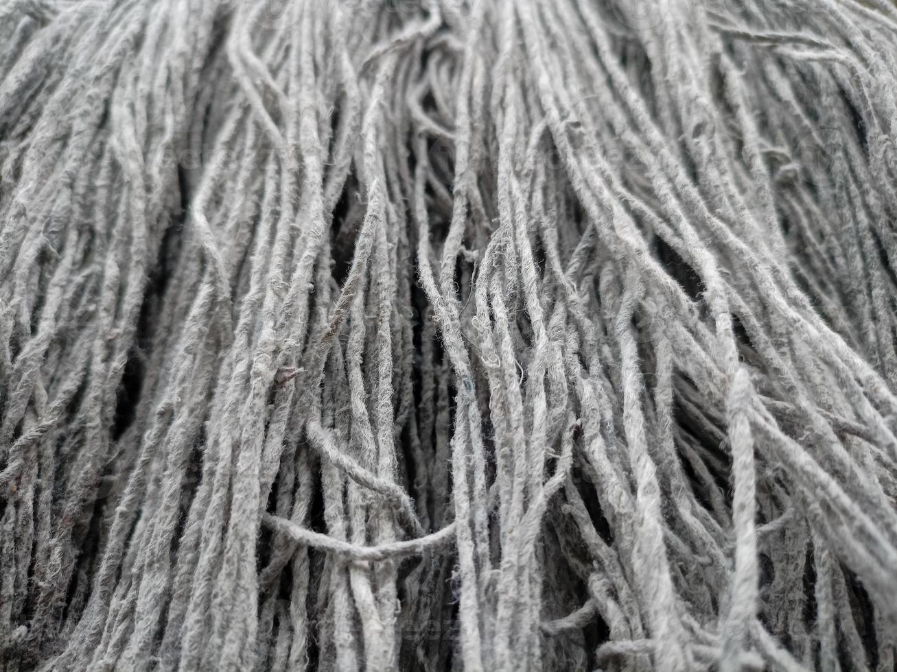 Close up of mop head, upside down and drying in the sun, cloth for mopping the floor photo