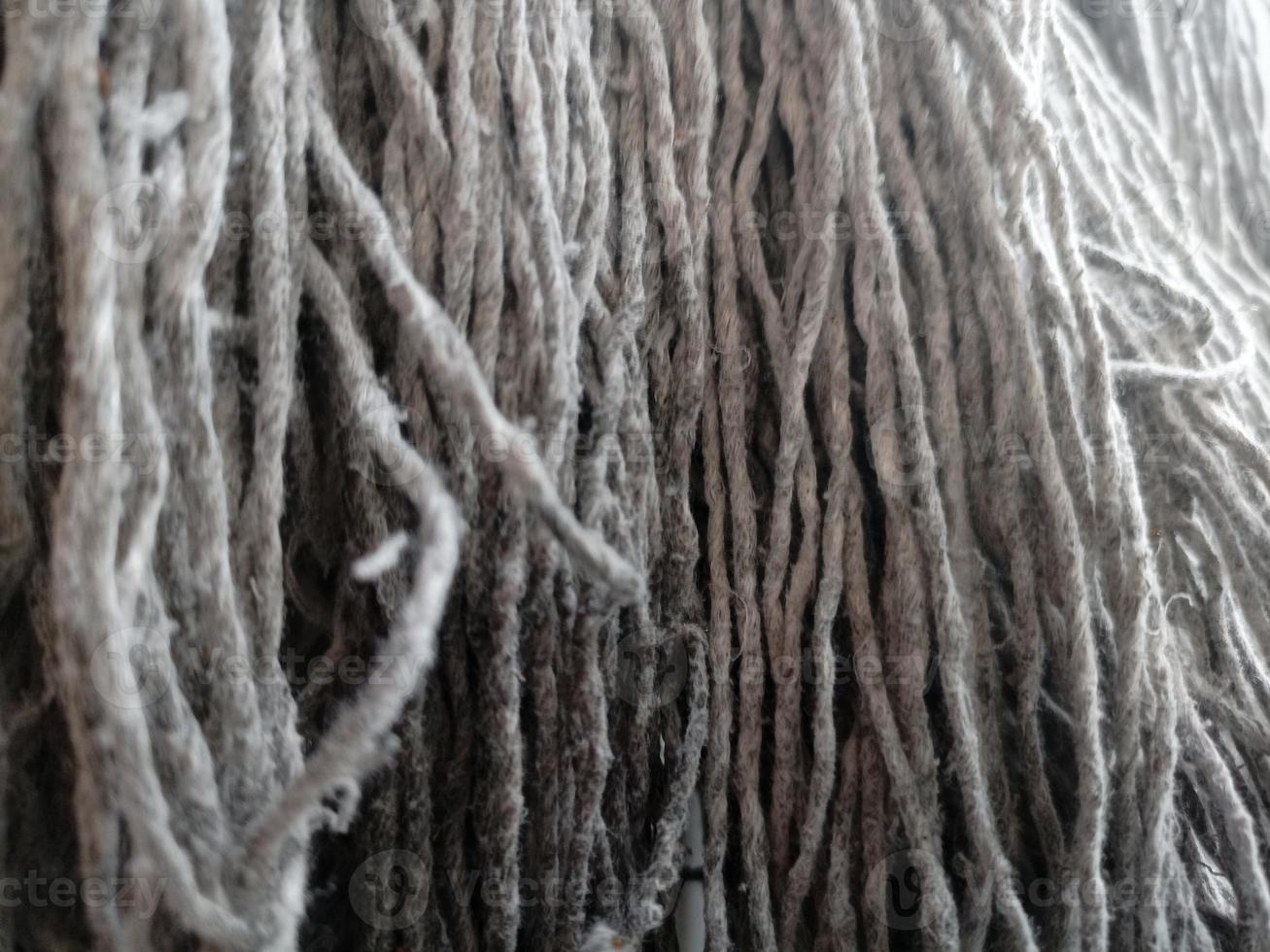 Close up of mop head, upside down and drying in the sun, cloth for mopping the floor photo