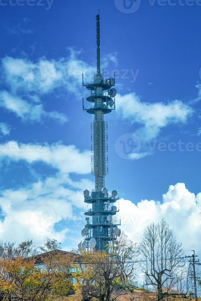 Telecommunications antenna tower for mobile phone with the blue sky background. photo