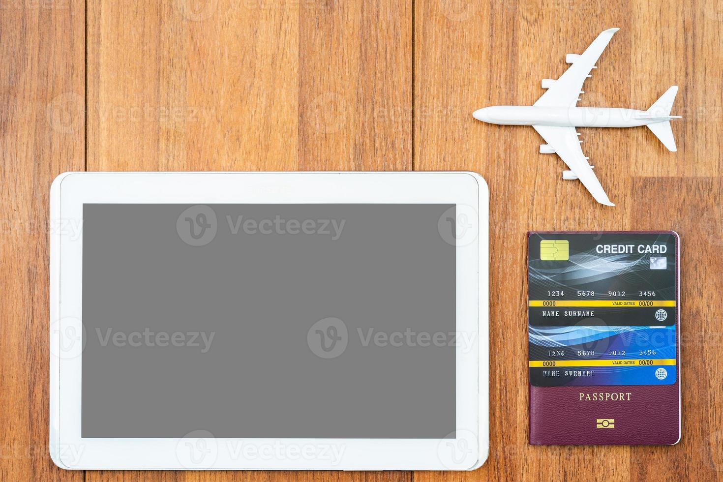Digital tablet mock up and credit card with passport on desk photo