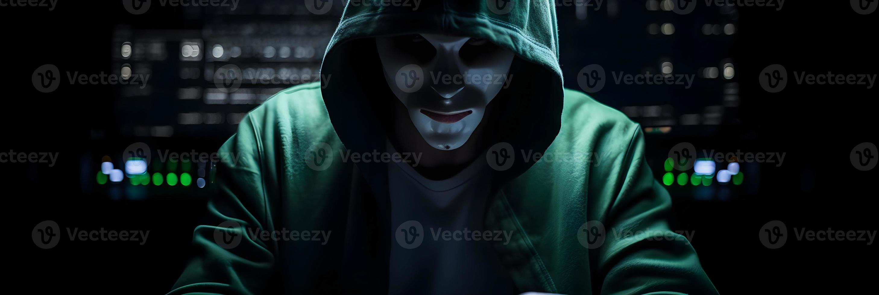 Unveiling the Enigmatic World of Cybercrime. A White Masked Hacker's Front View Amidst Dark Hood and Green Matrix Code Background photo
