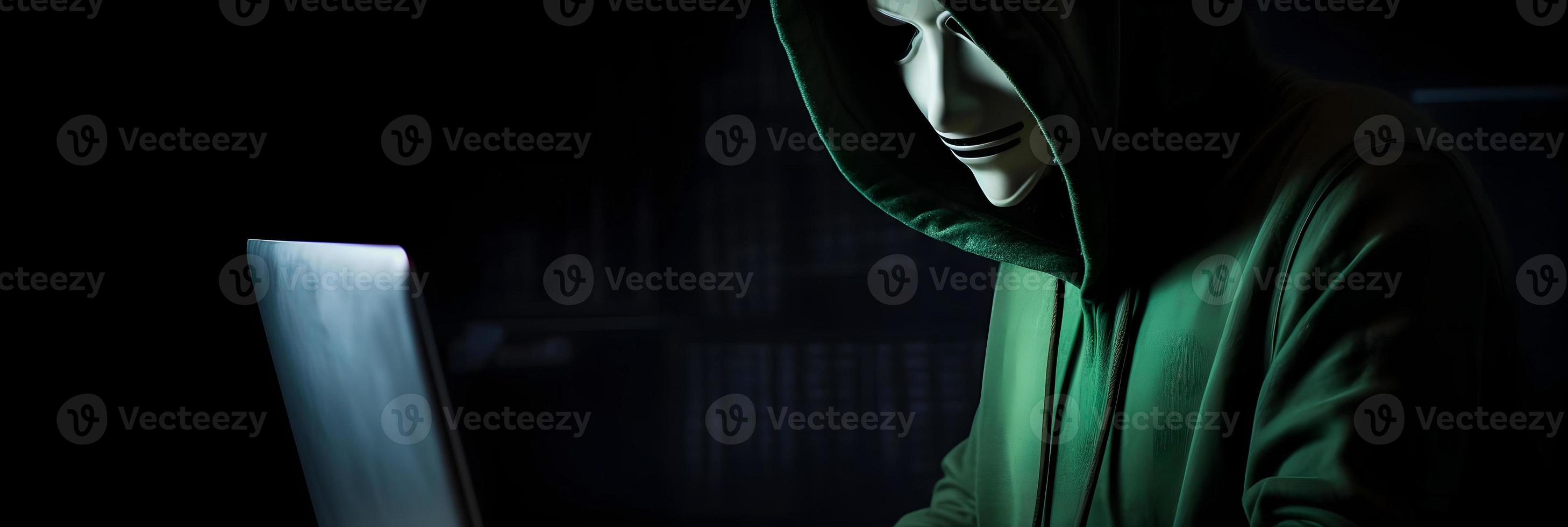Unveiling the Enigmatic World of Cybercrime. A White Masked Hacker's Front View Amidst Dark Hood and Green Matrix Code Background photo