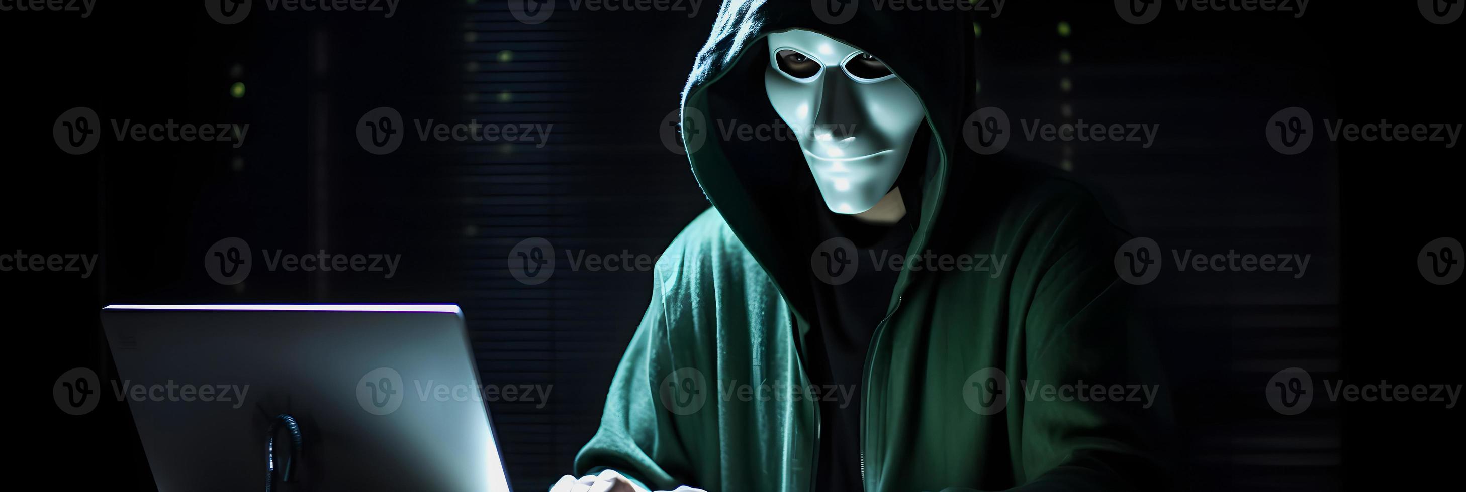 Unveiling the Enigmatic World of Cybercrime. A White Masked Hacker's Front View Amidst Dark Hood and Green Matrix Code Background photo