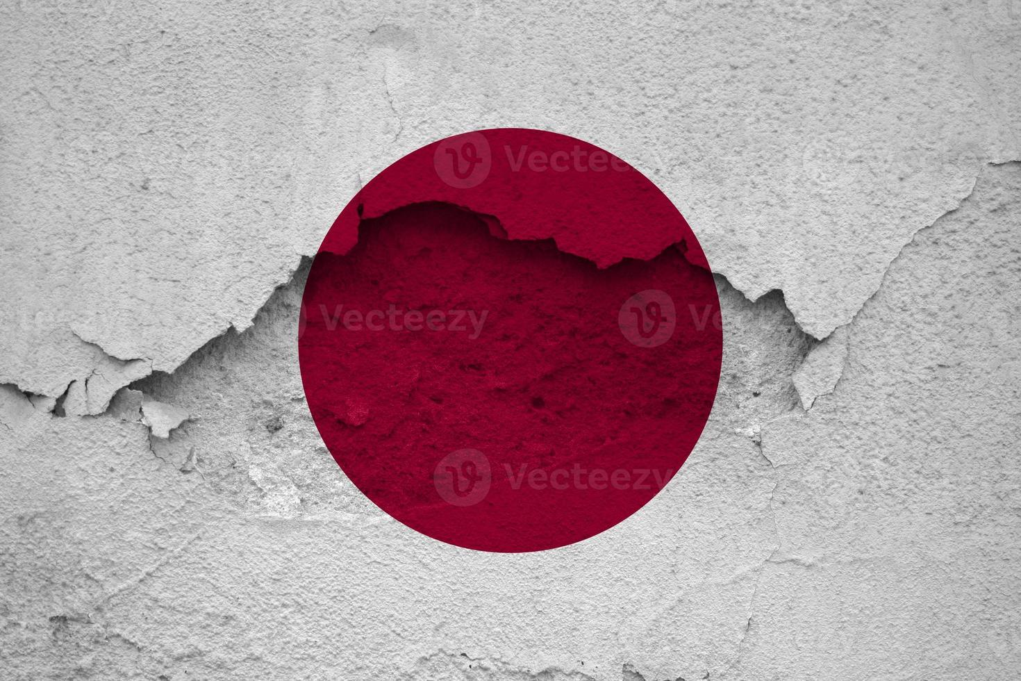 Earthquakes in Japan, flag Japan on a wall with cracks from an earthquake photo