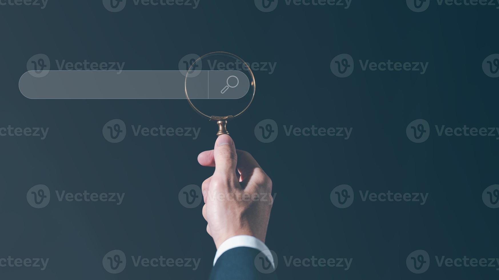 search engine concept, man holding magnifying glass to searching data photo