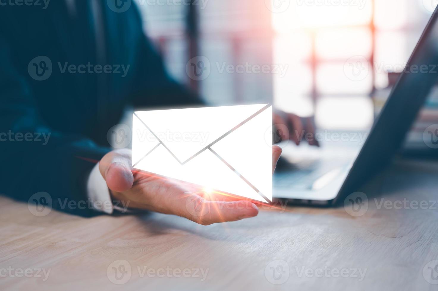 Email concept, businessman using computer laptop on table in office blurred background photo