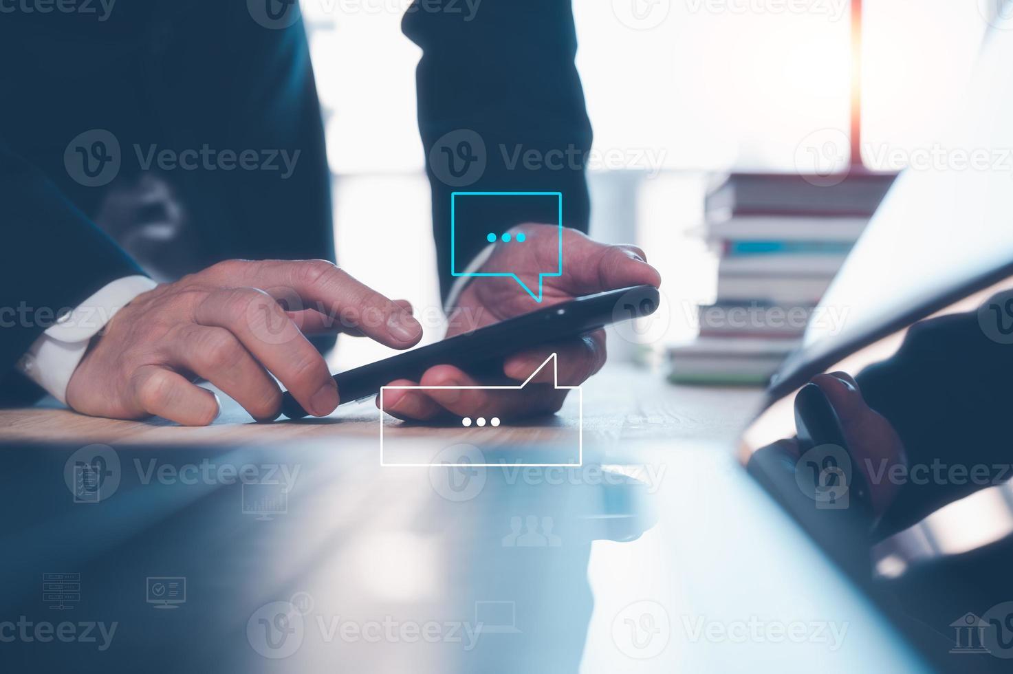 businessman using smartphone typing, chatting conversation working from home in chat box icons pop up. Social media marketing technology concept. photo