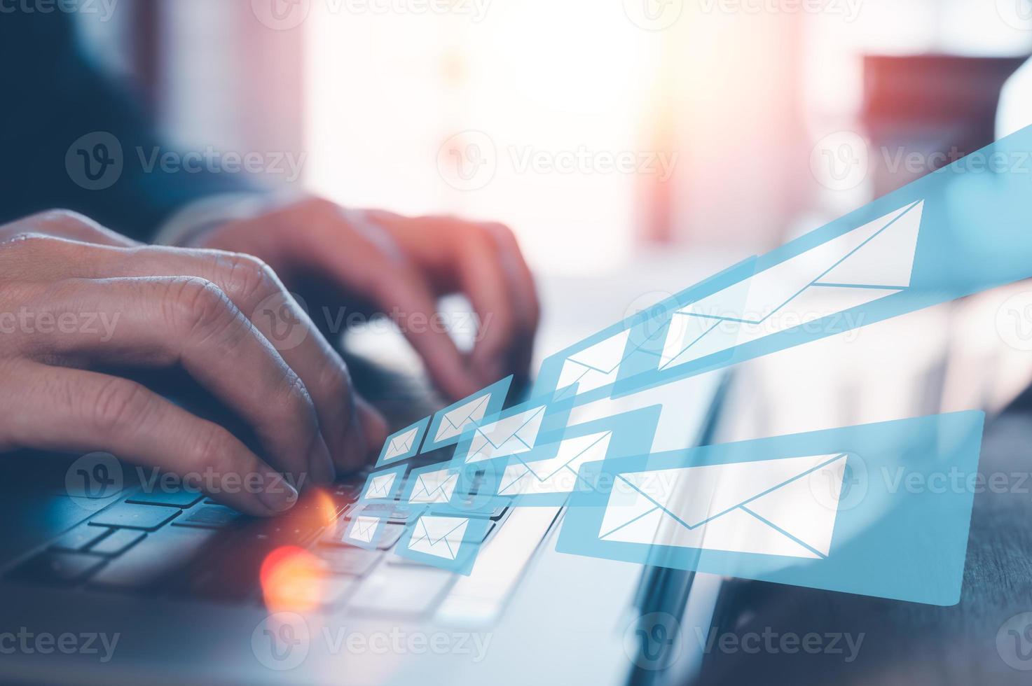 Email concept, businessman using computer laptop on table in office blurred background photo