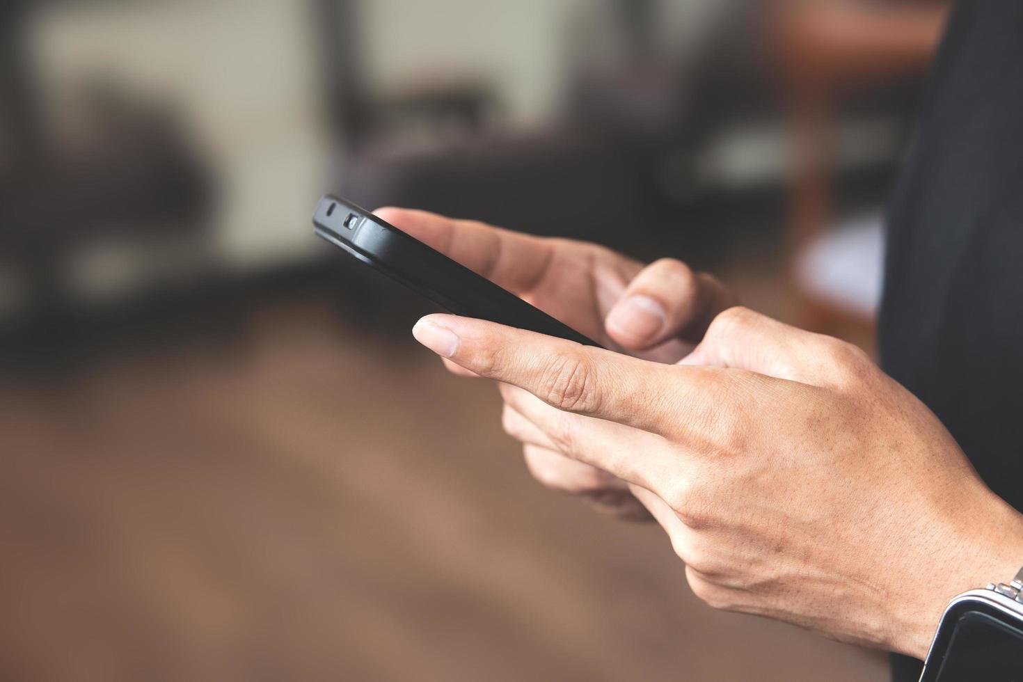 Close-up view of male hand using a smartphone. concept of social media and technology network photo