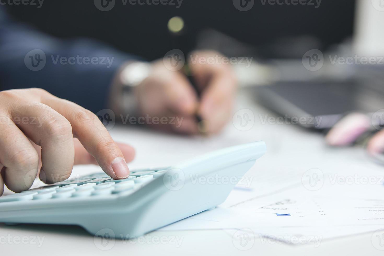 Male hand doing accounting, calculating bills, and expenses at home. Family budget bill payment checklist concept, pay bill check, income allocation plan, or Family budget hedge plan. photo