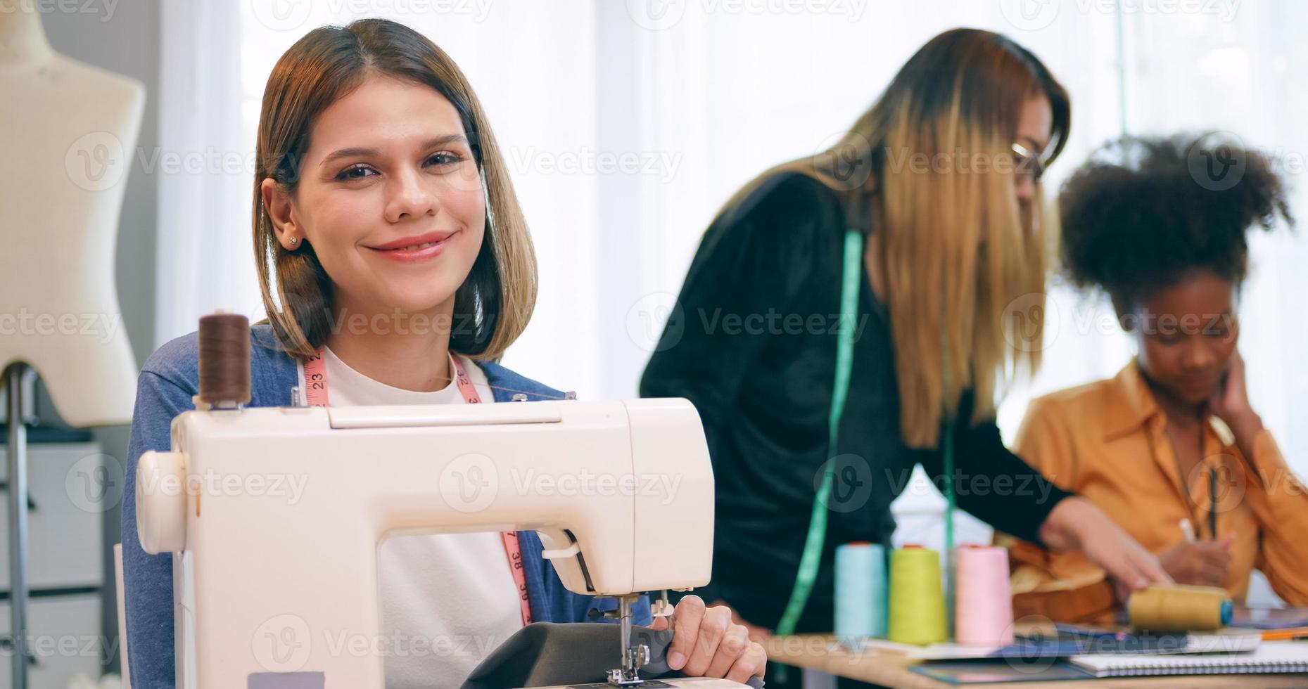 A group of young women are learning the profession of design and tailoring. photo